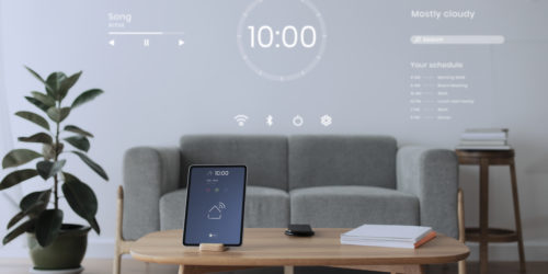 digital tablet screen with smart home controller on wooden table
